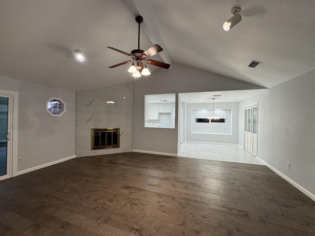 unfurnished living room with a high end fireplace, vaulted ceiling with beams, hardwood / wood-style flooring, and heating unit