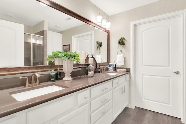 bathroom with vanity and a shower with shower door