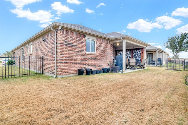 rear view of house with a yard and a patio area