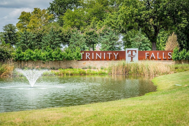 community / neighborhood sign featuring a water view