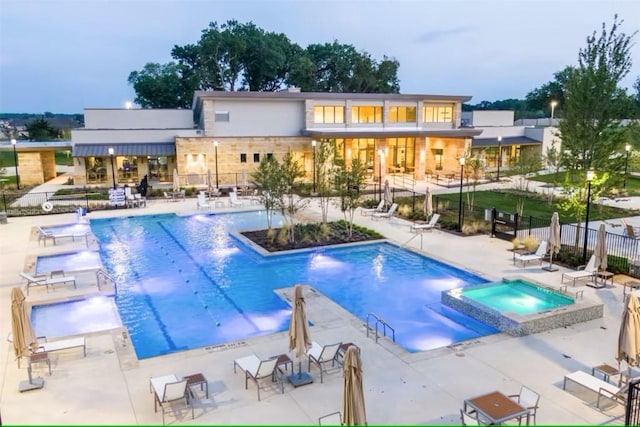 view of swimming pool featuring a patio area, pool water feature, and a community hot tub