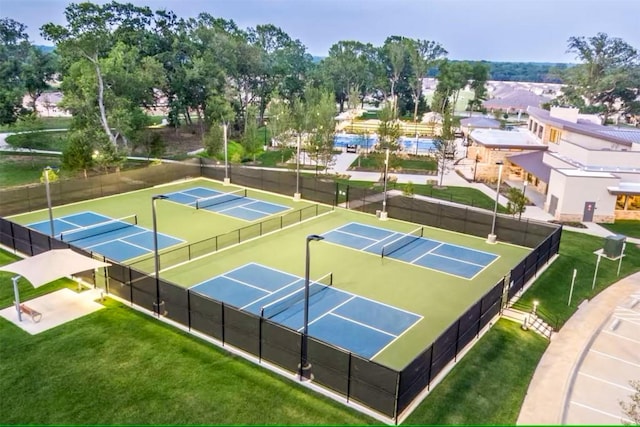 view of sport court with a lawn and basketball court