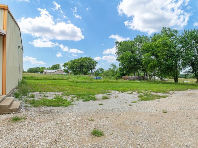 view of yard with a rural view