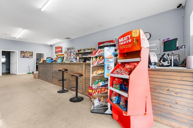 interior space with bar area and concrete flooring