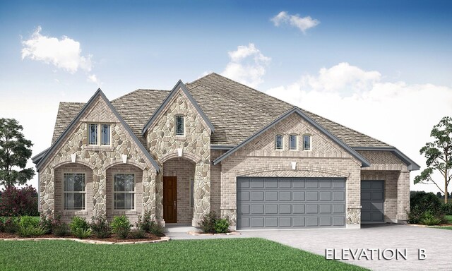 tudor-style house featuring a front lawn and a garage