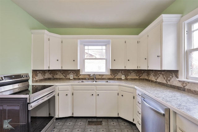 kitchen featuring a wealth of natural light, sink, appliances with stainless steel finishes, and tasteful backsplash