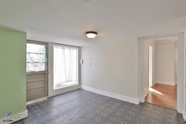 unfurnished room with dark hardwood / wood-style flooring