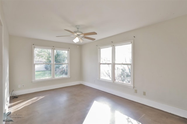 empty room featuring a wealth of natural light and ceiling fan