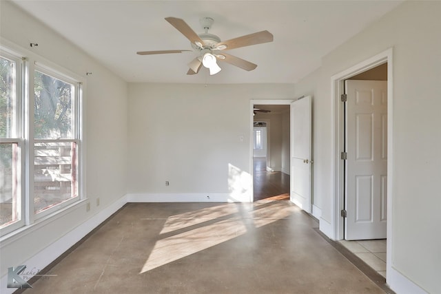 spare room featuring ceiling fan and a healthy amount of sunlight