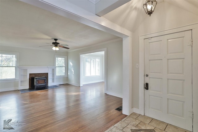 entrance foyer with light hardwood / wood-style flooring, plenty of natural light, ornamental molding, and ceiling fan