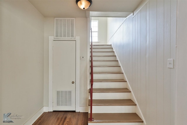 stairway with hardwood / wood-style floors