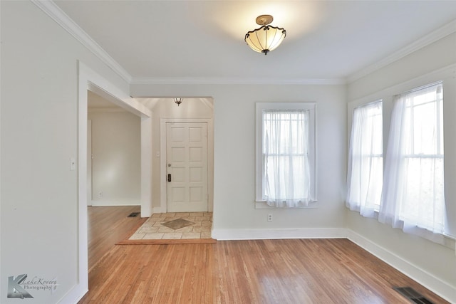 foyer with wood-type flooring and ornamental molding