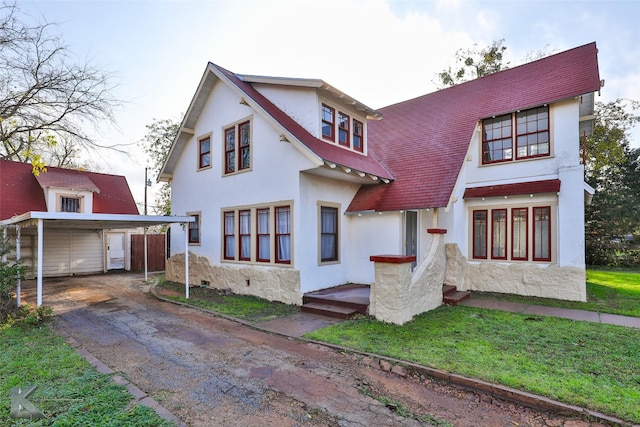 rear view of property featuring a lawn