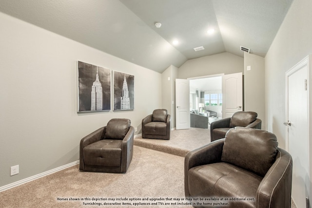 living area featuring lofted ceiling and carpet floors