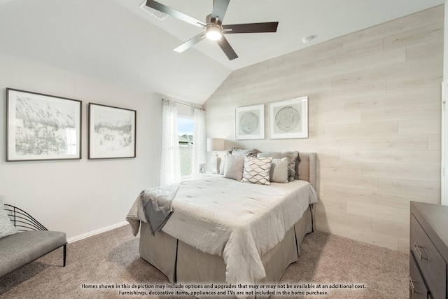 carpeted bedroom featuring ceiling fan, wooden walls, and vaulted ceiling