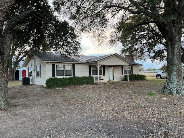 ranch-style home featuring central AC and covered porch