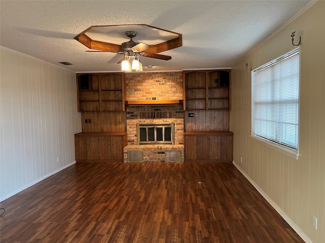 unfurnished living room featuring crown molding, dark wood-type flooring, and wood walls