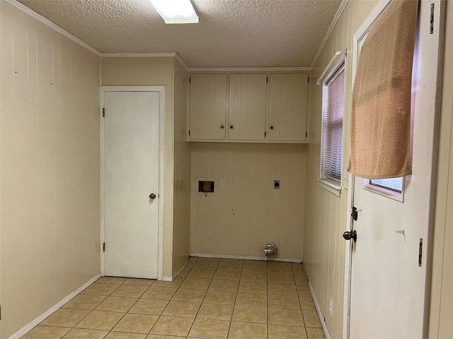 washroom featuring wood walls, cabinets, hookup for a washing machine, hookup for an electric dryer, and light tile patterned flooring