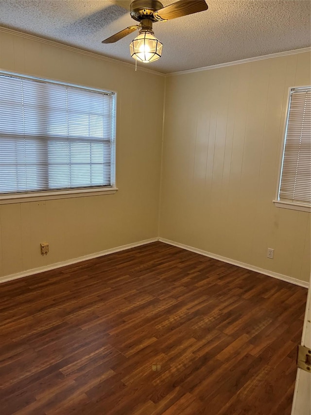 unfurnished room featuring a textured ceiling, dark hardwood / wood-style flooring, ceiling fan, and ornamental molding