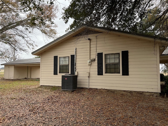 rear view of house with central air condition unit