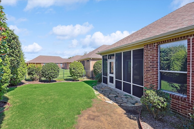 view of yard featuring a sunroom