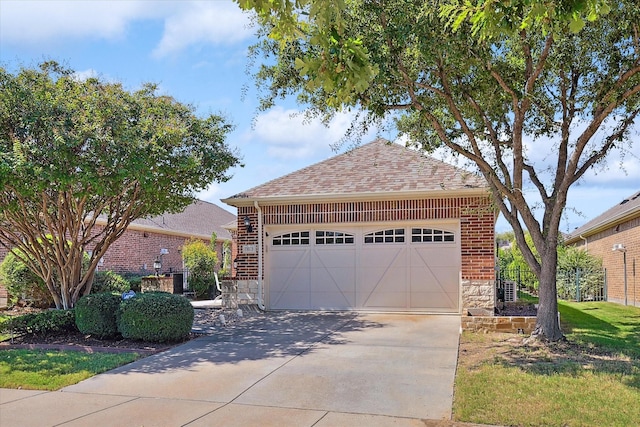 view of front of home with a garage and an outdoor structure