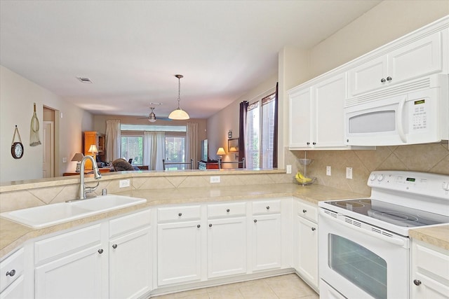 kitchen with pendant lighting, white appliances, sink, white cabinetry, and kitchen peninsula