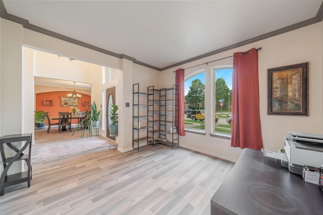 office area featuring light hardwood / wood-style flooring, ornamental molding, and an inviting chandelier