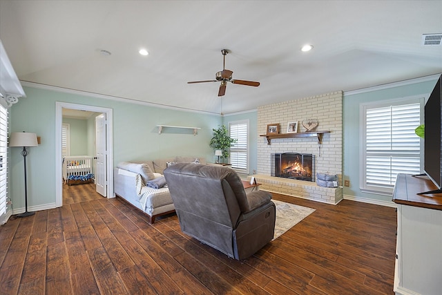 living room featuring ceiling fan, a healthy amount of sunlight, and dark wood-type flooring