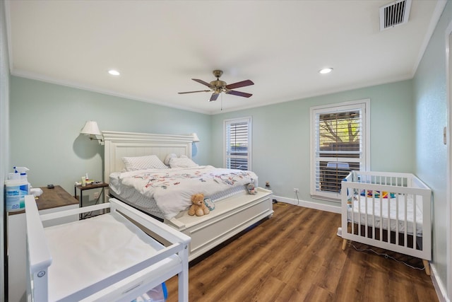 bedroom featuring ceiling fan, dark hardwood / wood-style flooring, and ornamental molding