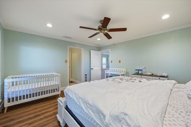 bedroom featuring ceiling fan, crown molding, and dark hardwood / wood-style floors