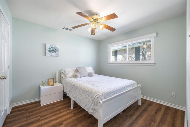 bedroom with ceiling fan and dark hardwood / wood-style floors