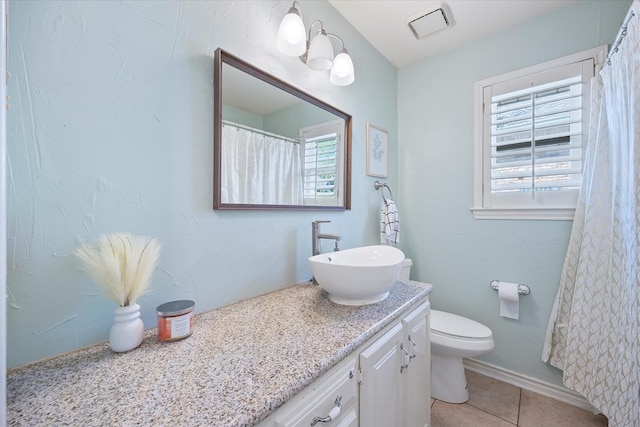 bathroom featuring tile patterned floors, vanity, and toilet