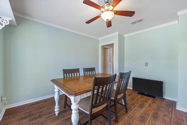 dining space with crown molding and dark wood-type flooring