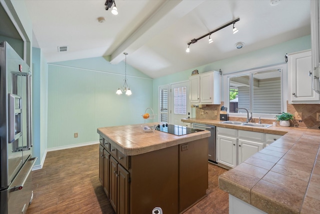 kitchen with white cabinetry, sink, a center island, stainless steel appliances, and pendant lighting