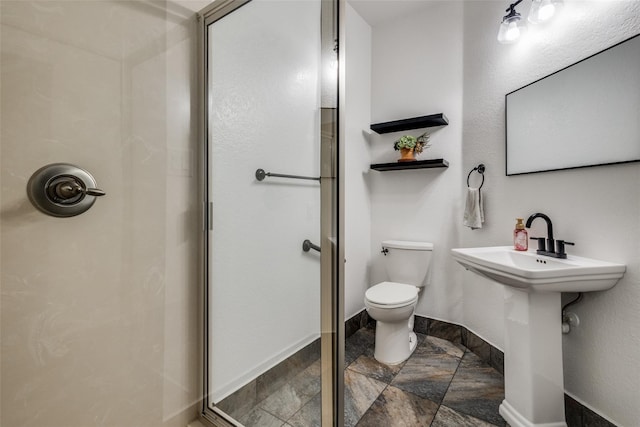 bathroom featuring toilet and walk in shower