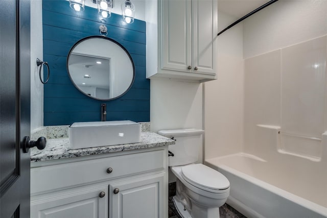 full bathroom with shower / bathing tub combination, vanity, wood walls, and toilet