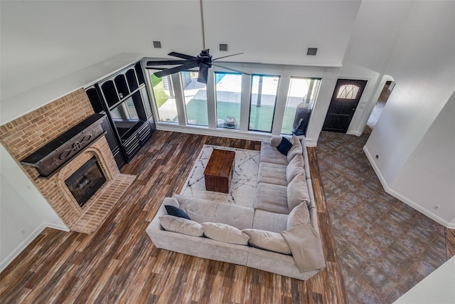 living room featuring ceiling fan, dark hardwood / wood-style flooring, and high vaulted ceiling