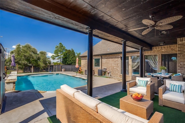 view of swimming pool with ceiling fan, a patio, and an outdoor hangout area