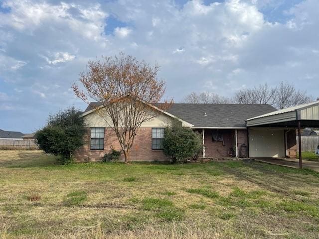 back of house featuring a yard and a carport