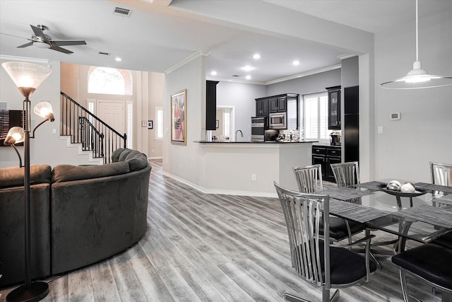 living room featuring crown molding, sink, ceiling fan, and hardwood / wood-style flooring