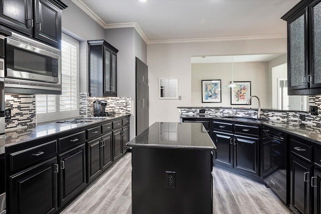 kitchen with a center island, light wood-type flooring, stainless steel appliances, and a wealth of natural light