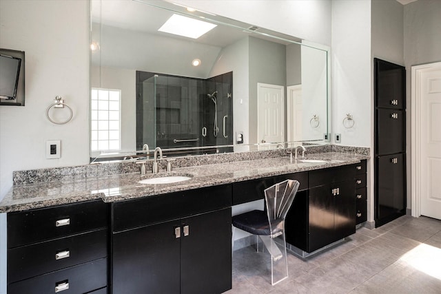 bathroom featuring tile patterned flooring, vanity, a shower with shower door, and lofted ceiling