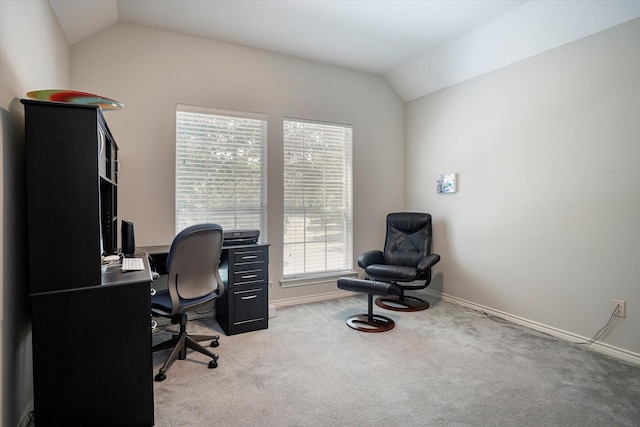 carpeted home office with vaulted ceiling