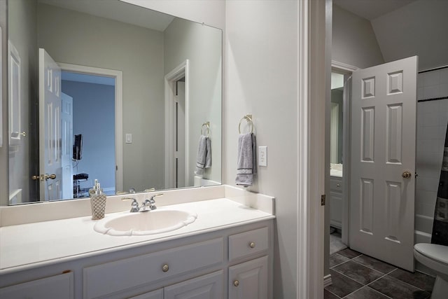 full bathroom featuring vanity, shower / bath combo, vaulted ceiling, tile patterned flooring, and toilet