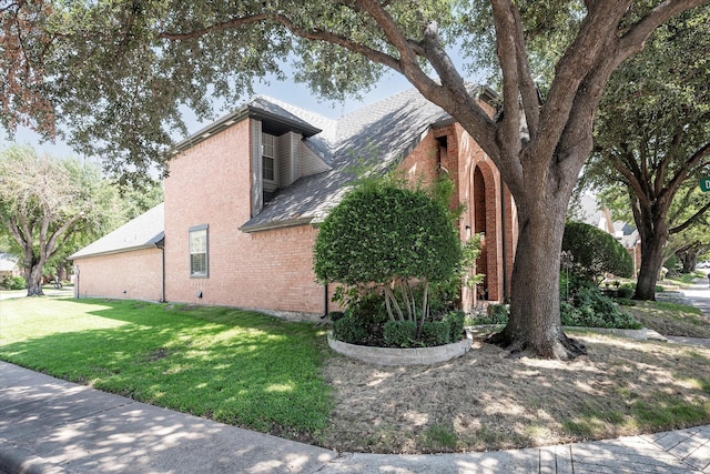 view of side of home with a lawn