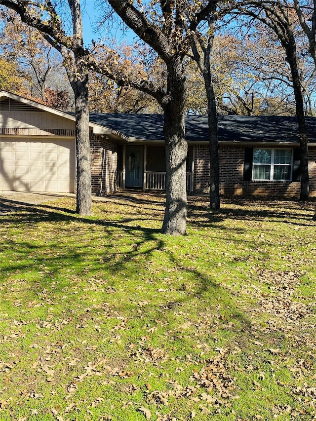 view of front of property with a garage and a front lawn