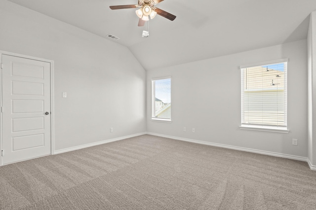 carpeted empty room with vaulted ceiling and ceiling fan