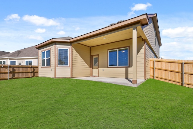 rear view of house with a yard and a patio