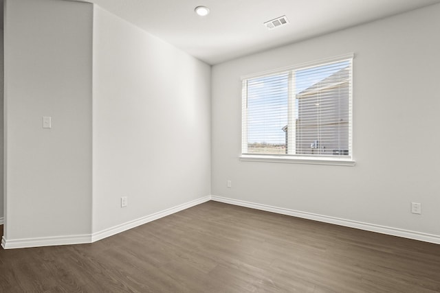 empty room with dark hardwood / wood-style floors